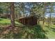 Rustic wooden outbuilding surrounded by trees, offering a tranquil setting at 29827 Gigi Rd, Evergreen, CO 80439
