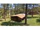 Rustic wooden outbuilding surrounded by trees, offering a tranquil setting at 29827 Gigi Rd, Evergreen, CO 80439