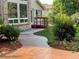Manicured backyard includes stamped concrete walkway, lush landscaping, and house view at 7762 S Eudora Ct, Centennial, CO 80122