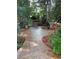 Well-maintained backyard features stamped concrete patio, mature trees, and wood storage shed at 7762 S Eudora Ct, Centennial, CO 80122