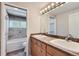 Well-lit bathroom featuring double sinks, a large mirror, and a tub/shower combination at 7762 S Eudora Ct, Centennial, CO 80122