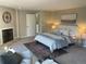 Bedroom featuring a fireplace, neutral tones, a plush rug and a comfortable sitting area at 7762 S Eudora Ct, Centennial, CO 80122