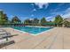 Large community pool with lounge chairs surrounded by lush greenery at 7762 S Eudora Ct, Centennial, CO 80122
