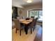 Dining room featuring hardwood floors, textured rug, and a wooden table with upholstered chairs at 7762 S Eudora Ct, Centennial, CO 80122