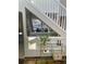 Entryway with a white staircase banister, view of the living room, and tiled floors creating an inviting space at 7762 S Eudora Ct, Centennial, CO 80122