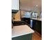 Spacious kitchen featuring modern appliances, dark green cabinets, white countertops and hardwood floors at 7762 S Eudora Ct, Centennial, CO 80122