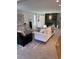 Cozy living room with neutral furniture, plush carpeting, dark fireplace, and built-in shelving at 7762 S Eudora Ct, Centennial, CO 80122