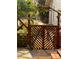 Decorative lattice gate in backyard leads to garden area with mature plantings at 7762 S Eudora Ct, Centennial, CO 80122