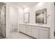 Bathroom with dual vanities, modern fixtures, and tiled floors at 631 Sunrise St, Erie, CO 80516