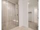 Bathroom featuring a tiled shower with a glass door at 631 Sunrise St, Erie, CO 80516
