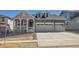 Charming two-story home with a two car garage, landscaped front yard, and covered front porch at 631 Sunrise St, Erie, CO 80516
