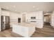 Bright and airy kitchen with a large center island, stainless steel appliances, and wood-look flooring at 631 Sunrise St, Erie, CO 80516
