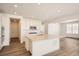 Bright kitchen with a large center island, stainless steel appliances, recessed lighting, and wood-look floors at 631 Sunrise St, Erie, CO 80516