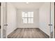 Office with wood-look flooring, a large window, and a modern light fixture at 631 Sunrise St, Erie, CO 80516