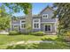 Landscaped backyard featuring a well-maintained lawn, stone patio, and mature trees for privacy at 16257 E Belleview Pl, Centennial, CO 80015