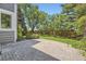 Private backyard featuring a stone patio surrounded by mature trees and lush landscaping at 16257 E Belleview Pl, Centennial, CO 80015