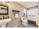 Modern bathroom featuring a walk-in shower, patterned tile floor and pedestal sink at 16257 E Belleview Pl, Centennial, CO 80015