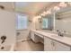 Bathroom features a double sink vanity and a window with shutters, offering ample natural light at 16257 E Belleview Pl, Centennial, CO 80015