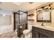 Modern bathroom features a glass-enclosed shower, rustic vanity, and stylish fixtures at 16257 E Belleview Pl, Centennial, CO 80015