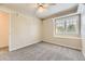 Bright bedroom features neutral walls, plush carpeting, and a window with plantation shutters at 16257 E Belleview Pl, Centennial, CO 80015