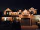 A lovely two-story house is adorned with festive Christmas lights along the roofline, providing a warm and inviting curb appeal at 16257 E Belleview Pl, Centennial, CO 80015