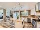 Bright, open kitchen with an island and views into the living room at 16257 E Belleview Pl, Centennial, CO 80015