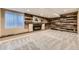 Cozy living room with a stone accent wall, a wooden mantel, and a modern electric fireplace at 16257 E Belleview Pl, Centennial, CO 80015