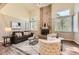 Bright living room featuring a brick fireplace, vaulted ceilings, and modern decor at 16257 E Belleview Pl, Centennial, CO 80015