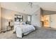 Large primary bedroom with vaulted ceiling, carpet floors and adjacent bathroom at 16257 E Belleview Pl, Centennial, CO 80015