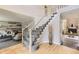 Elegant staircase with carpet steps and a wooden handrail at 16257 E Belleview Pl, Centennial, CO 80015