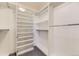 Spacious walk-in closet with extensive shelving and hanging rods, perfect for organization at 16257 E Belleview Pl, Centennial, CO 80015