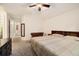 Bright bedroom featuring soft carpeting, a ceiling fan, and access to the en-suite bathroom at 22070 Day Star Dr, Parker, CO 80138