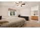 Relaxing bedroom featuring neutral walls, soft carpeting, and an ensuite bathroom with a vanity at 22070 Day Star Dr, Parker, CO 80138