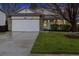 Charming two-story home with stone accents, well-manicured lawn, and attached garage at 22070 Day Star Dr, Parker, CO 80138