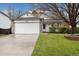 Charming single-Gathering home featuring a two-car garage, stone accents and well-manicured lawn at 22070 Day Star Dr, Parker, CO 80138