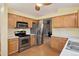 Cozy kitchen with stainless steel appliances, wood cabinets, and a charming breakfast nook at 22070 Day Star Dr, Parker, CO 80138