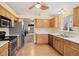 Cozy kitchen with stainless steel appliances, wood cabinets, and a charming breakfast nook at 22070 Day Star Dr, Parker, CO 80138