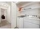 Laundry room with washer, dryer, and shelves for storage at 22070 Day Star Dr, Parker, CO 80138