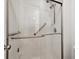 Bright shower with grab bars, tiled walls, and a clear glass door for accessibility and style at 22070 Day Star Dr, Parker, CO 80138