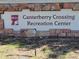 Signage for the Canterbury Crossing Recreation Center nestled in a stone wall at 22070 Day Star Dr, Parker, CO 80138