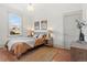 Spacious bedroom with hardwood floors, large window, and neutral color palette at 2929 N Josephine St, Denver, CO 80205