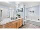 Bright bathroom featuring tile floors, wood vanity, and a shower at 1438 Little Raven St # 310, Denver, CO 80202