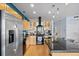Contemporary kitchen with stainless steel appliances, island with seating, and sleek black countertops at 1438 Little Raven St # 310, Denver, CO 80202