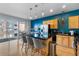 Bright kitchen with stainless steel appliances and an island with bar stools at 1438 Little Raven St # 310, Denver, CO 80202