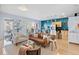 Bright living room featuring hardwood floors, a modern leather sofa, and balcony access at 1438 Little Raven St # 310, Denver, CO 80202