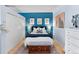 Comfortable main bedroom with a blue accent wall, stylish decor, and ample storage at 1438 Little Raven St # 310, Denver, CO 80202