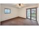 Bright, carpeted bedroom with a sliding glass door to a balcony, offering natural light and views at 10293 E Peakview Ave # F104, Englewood, CO 80111