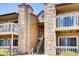 Exterior view of condos with stone accents, stairs and balconies at 10293 E Peakview Ave # F104, Englewood, CO 80111