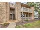 Charming multi-story condo building with stone accents, wood trim, and inviting outdoor balconies at 10293 E Peakview Ave # F104, Englewood, CO 80111