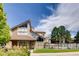 Striking modern home featuring a peaked roof, expansive windows and manicured lawn at 10293 E Peakview Ave # F104, Englewood, CO 80111